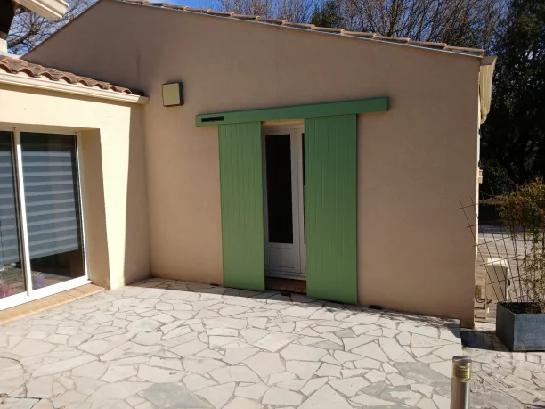 Volet coulissant vert en aluminium avec motorisation solaire à Villeneuve-lès-Avignon ouvert